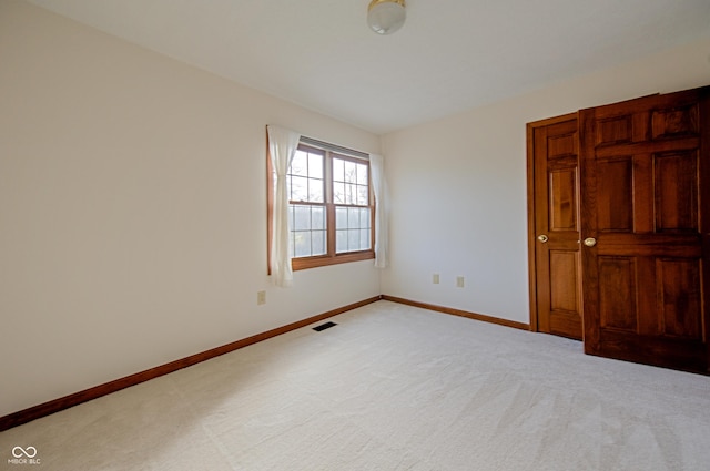 unfurnished bedroom featuring light carpet