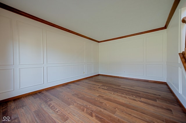 spare room with ornamental molding and dark hardwood / wood-style flooring