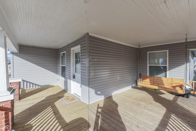 wooden terrace featuring covered porch