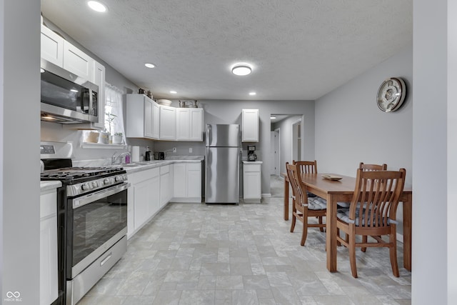 kitchen featuring white cabinetry, stainless steel appliances, and sink