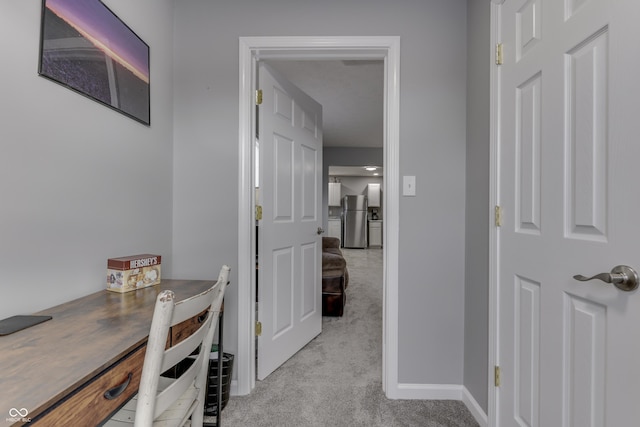 hall with light colored carpet