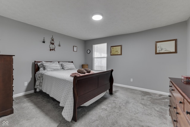 carpeted bedroom featuring a textured ceiling