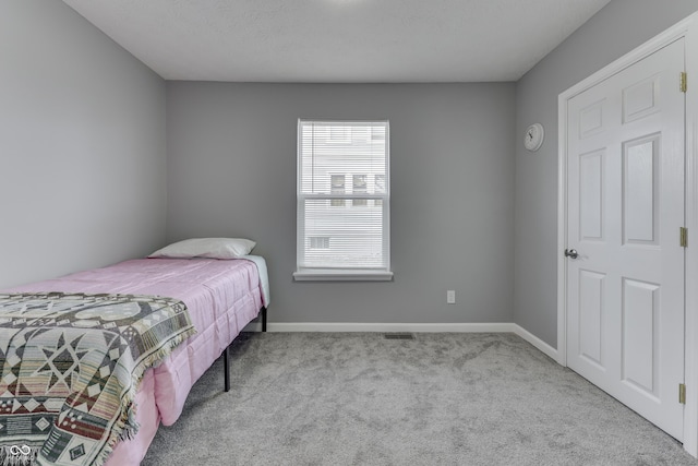 bedroom featuring light colored carpet