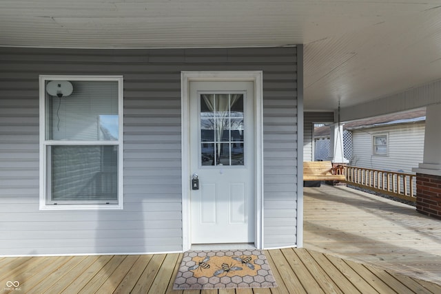 view of exterior entry with a porch