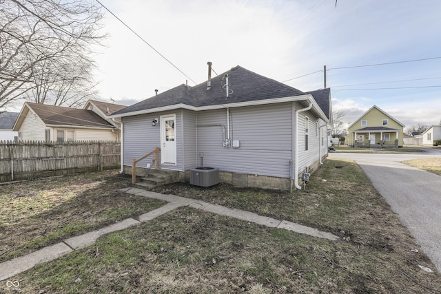 rear view of house featuring central AC