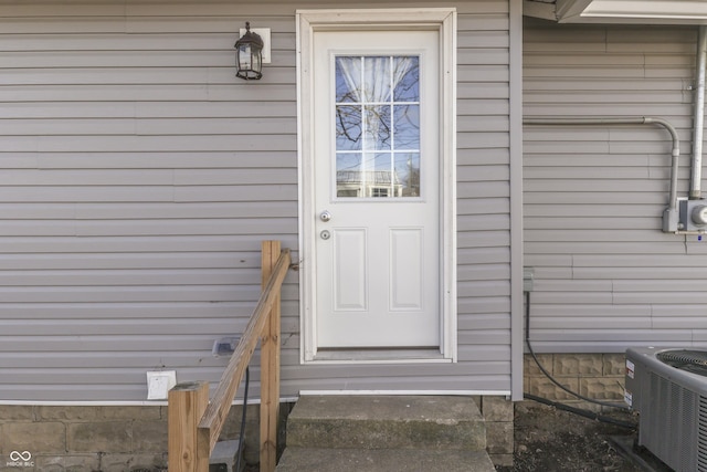 doorway to property featuring central air condition unit