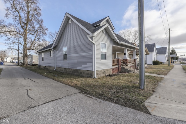 view of side of property with a porch