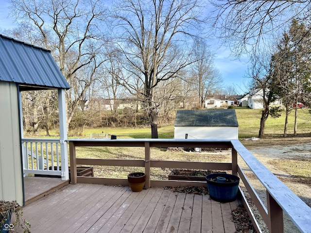 deck featuring a yard and a storage unit