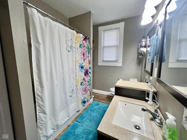 bathroom with a shower with shower curtain, vanity, toilet, and hardwood / wood-style floors