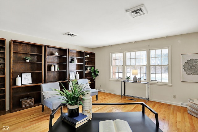 home office featuring light wood finished floors, baseboards, and visible vents