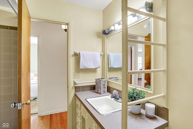 bathroom with vanity and wood finished floors