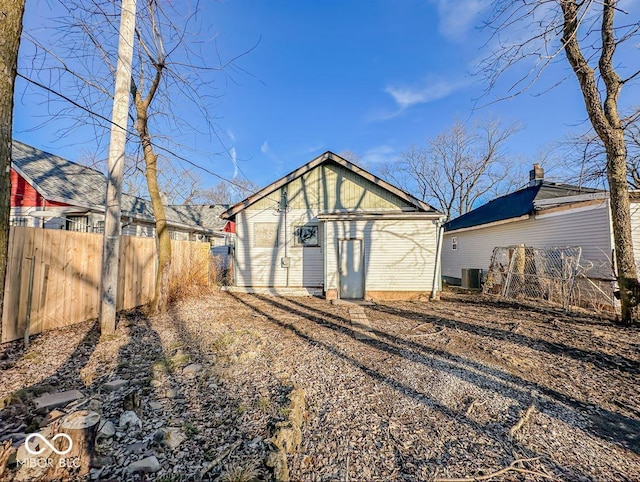 back of house featuring an outdoor structure and cooling unit