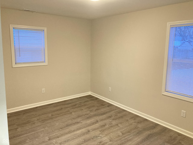 spare room with dark wood-type flooring