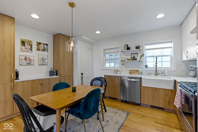 dining space with sink and light hardwood / wood-style flooring