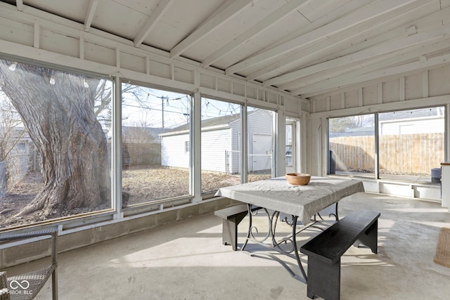 sunroom with lofted ceiling and a healthy amount of sunlight