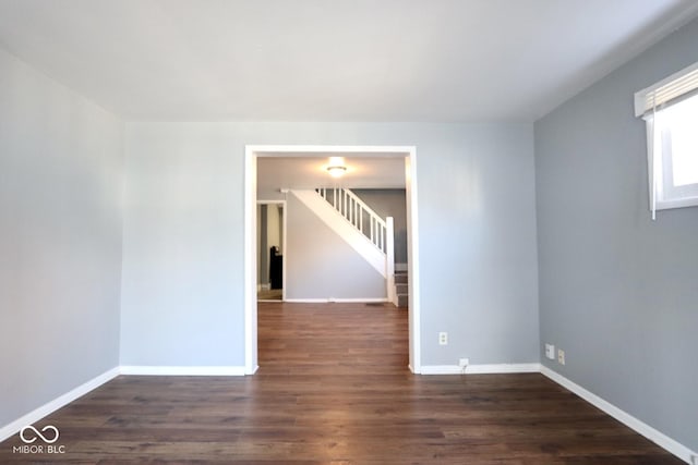 empty room featuring dark wood-type flooring