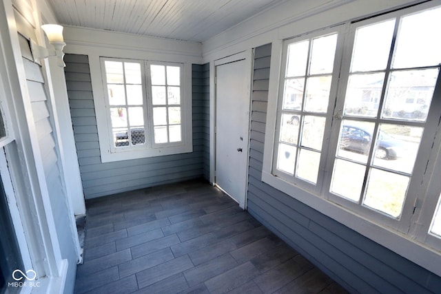 unfurnished sunroom with wood ceiling