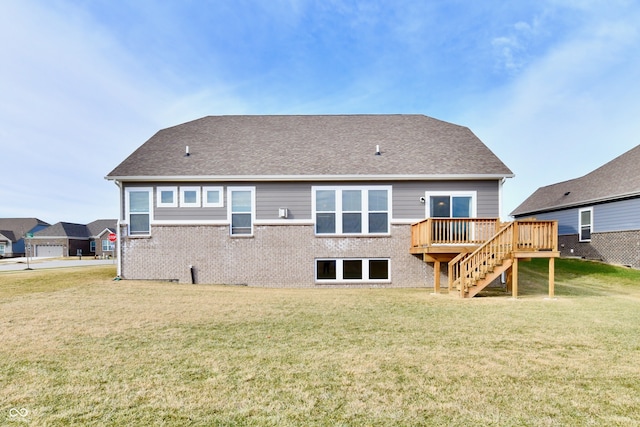 rear view of house with a wooden deck and a yard