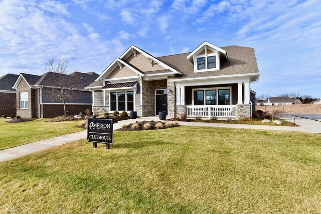 craftsman-style home featuring a front yard and covered porch