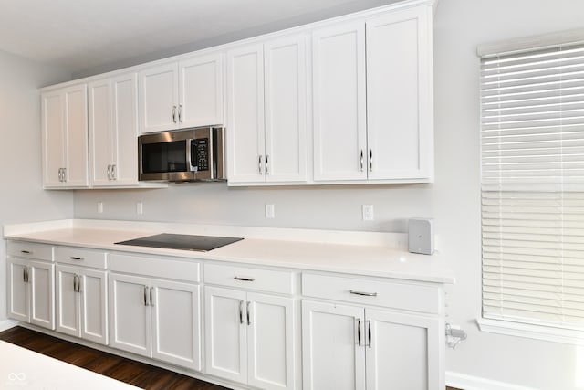 kitchen featuring white cabinets and black electric cooktop