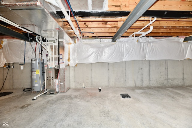 basement with electric water heater and heating unit