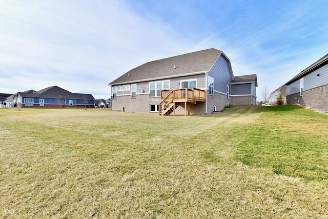 rear view of house featuring a yard and a deck