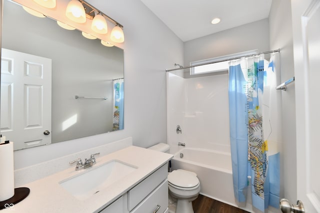 full bathroom with shower / tub combo, vanity, hardwood / wood-style floors, and toilet