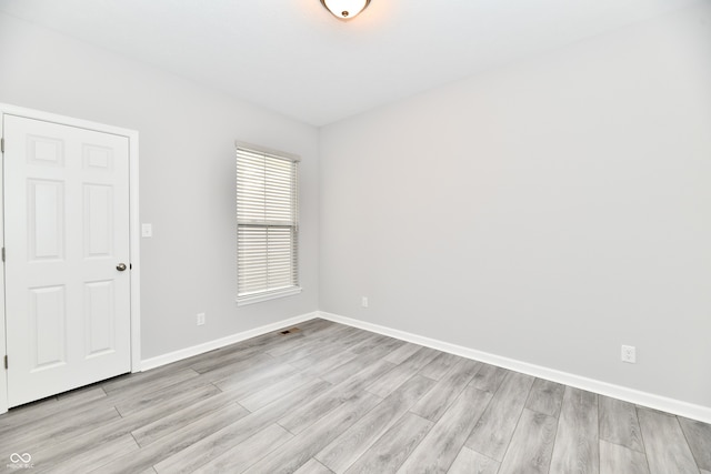 unfurnished room with light hardwood / wood-style flooring