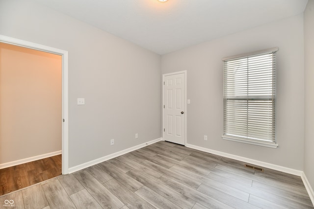 unfurnished room featuring light wood-type flooring