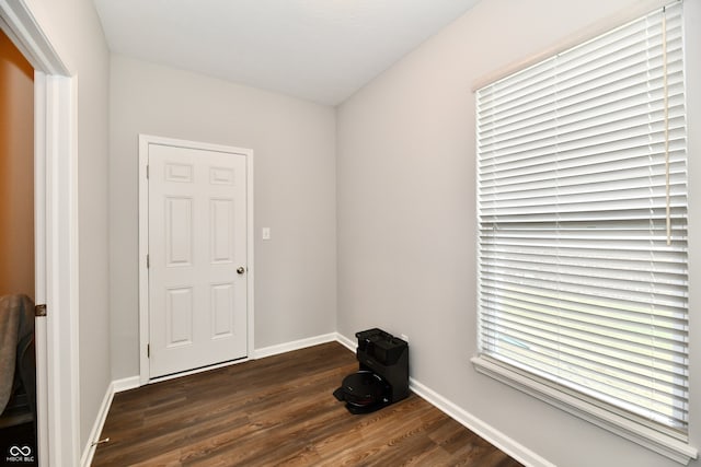 unfurnished room featuring dark wood-type flooring