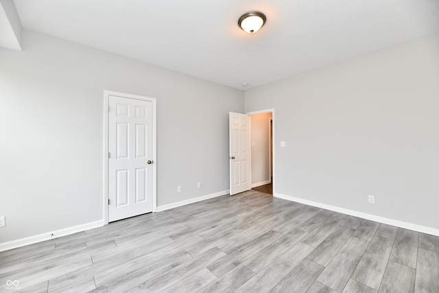 spare room with light hardwood / wood-style flooring