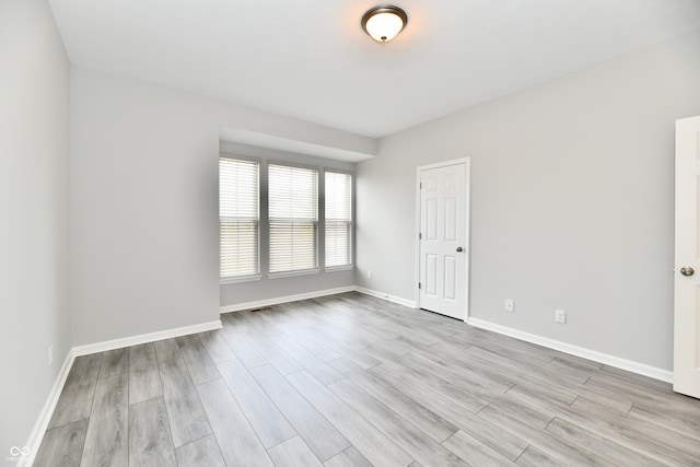 unfurnished room featuring light wood-type flooring