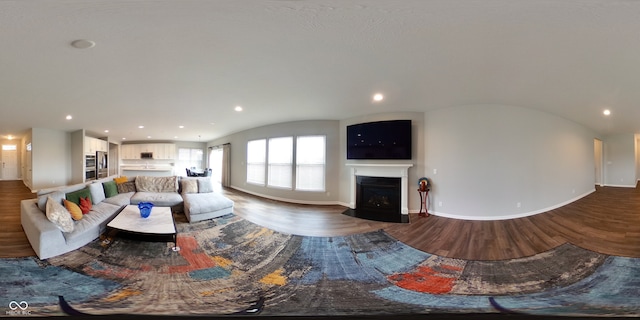 living room with wood-type flooring and vaulted ceiling