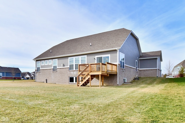 back of house featuring a lawn and a deck