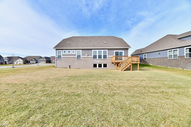 back of house featuring a wooden deck and a yard