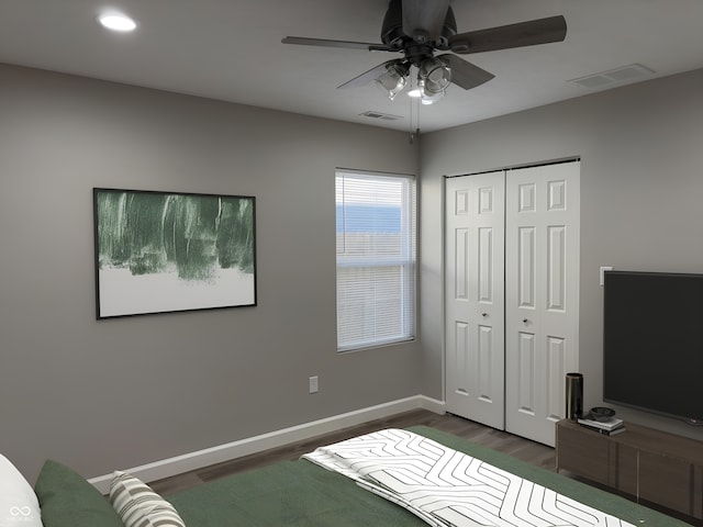 bedroom with ceiling fan, dark hardwood / wood-style flooring, and a closet