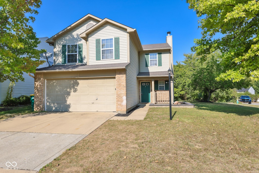 view of front of home with a garage and a front yard