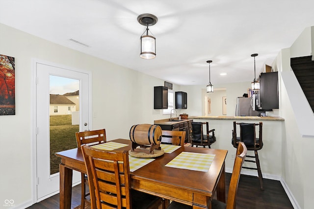 dining area featuring dark wood-type flooring and sink