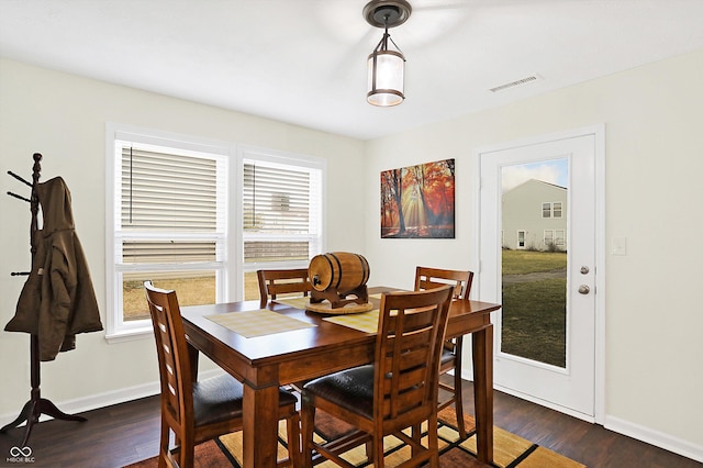 dining space with dark hardwood / wood-style flooring