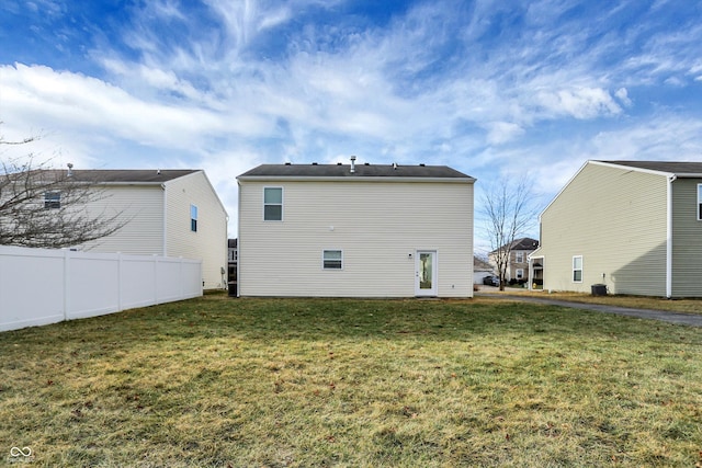 back of property featuring a lawn