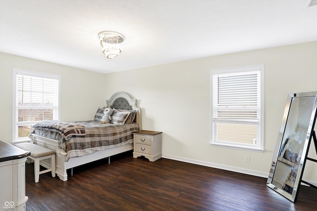 bedroom with dark hardwood / wood-style floors