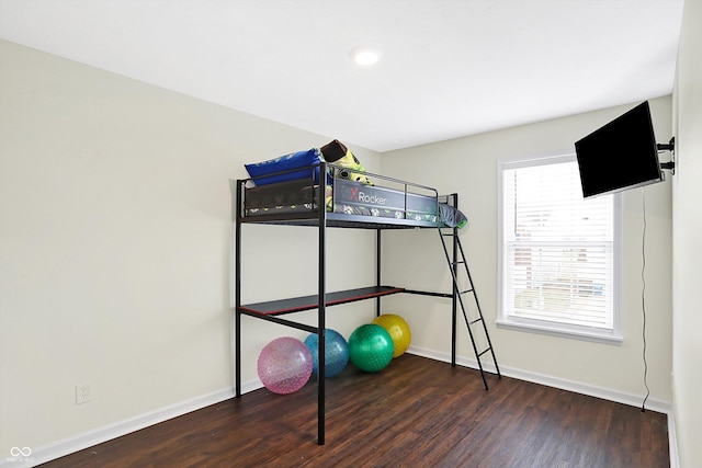 unfurnished bedroom with dark wood-type flooring