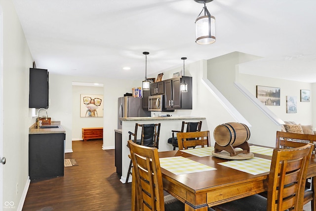 dining space with sink and dark hardwood / wood-style floors