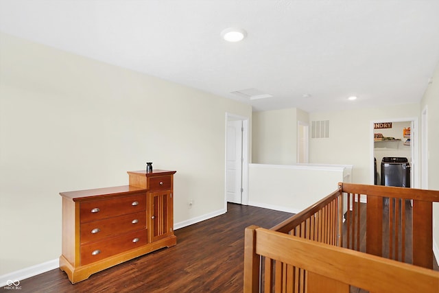 corridor featuring washer and dryer and dark hardwood / wood-style flooring