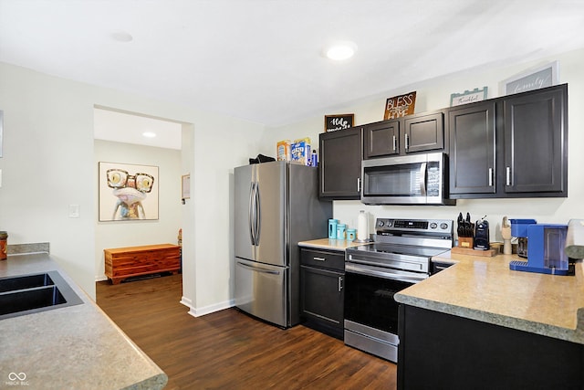 kitchen with stainless steel appliances and dark hardwood / wood-style floors