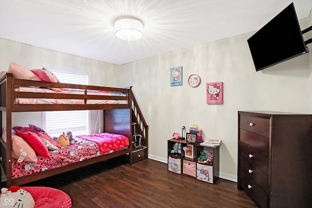 bedroom with dark hardwood / wood-style flooring