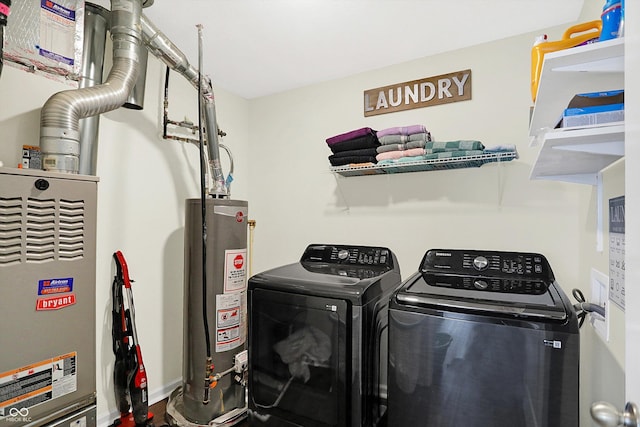 laundry area with washer and clothes dryer and gas water heater