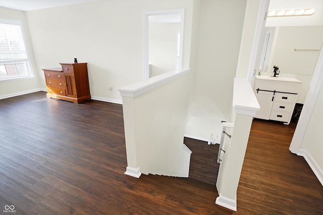 staircase with sink and hardwood / wood-style floors