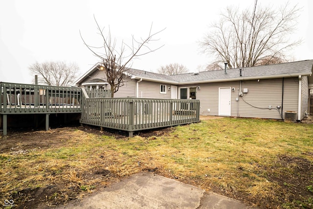 back of property featuring a yard and a deck