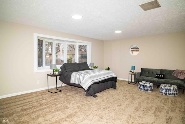 carpeted bedroom featuring a textured ceiling